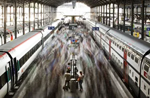 A long exposure picture shows commuters walking on a platform after leaving a train A long exposure picture shows commuters walking on a platform after leaving a train