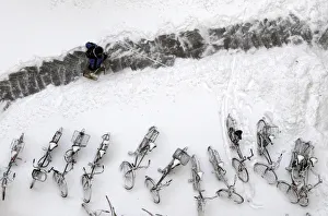 A man clears snow to form a path in a yard during in Berlin A man clears snow to form a path in a yard during in Berlin