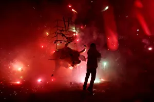 Man enjoys the fireworks exploding from a traditional bull figure known as El Torito in Man enjoys the fireworks exploding from a traditional bull figure known as El Torito in