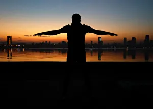 A man exercises early in the morning along the Arabian Sea in Mumbai, India A man exercises early in the morning along the Arabian Sea in Mumbai, India