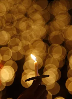 A man holds a candle during a Christmas mass at the Gelora Bung Karno stadium in Jakarta A man holds a candle during a Christmas mass at the Gelora Bung Karno stadium in Jakarta