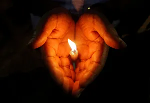 A man holds a candle during a vigil to show solidarity with the victims of Sri Lanka's A man holds a candle during a vigil to show solidarity with the victims of Sri Lanka's
