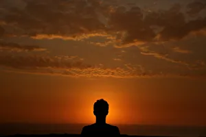 A man observes sunset in front of Limas Miraflores district in Peru A man observes sunset in front of Limas Miraflores district in Peru