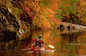 A man paddles his canoe down the river Garry near Killiekrankie, Scotland A man paddles his canoe down the river Garry near Killiekrankie, Scotland