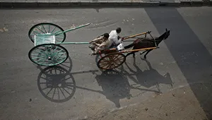 A man pulls a newly purchased cart while travelling in another horse-cart through A man pulls a newly purchased cart while travelling in another horse-cart through
