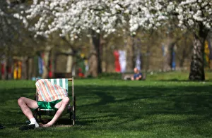 A man relaxes in the sunshine in St James Park in central London A man relaxes in the sunshine in St James Park in central London
