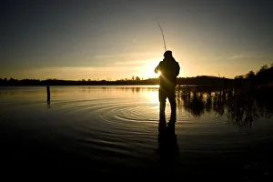 A man is seen fishing at sunset in Lavey Lough near Cavan A man is seen fishing at sunset in Lavey Lough near Cavan
