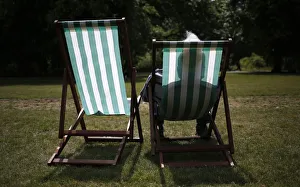 A man sits in a deck chair on a sunny day in St. James Park in London, Britain A man sits in a deck chair on a sunny day in St. James Park in London, Britain