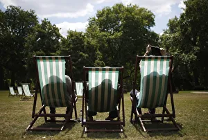 A man takes his jacket off as he settles into his deck chair on a sunny day in St A man takes his jacket off as he settles into his deck chair on a sunny day in St
