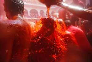 A man throws water on a woman during Huranga, a game played between men A man throws water on a woman during Huranga, a game played between men
