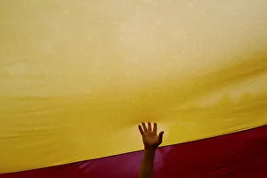 A man touches a Spanish flag during a demonstration in favour of a unified Spain a day A man touches a Spanish flag during a demonstration in favour of a unified Spain a day