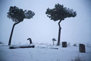 A man walks during a heavy snowfall in downtown Rome A man walks during a heavy snowfall in downtown Rome