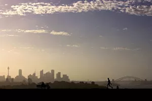 Images Dated 30th December 2005: Man walks as another looks towards city of Sydney on hot summers day in Australia
