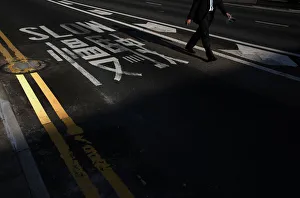 A man walks past a sign on a road blocked by pro-democracy protesters at the financial A man walks past a sign on a road blocked by pro-democracy protesters at the financial