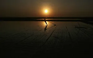 A man works on a salt pan in Kharaghodha village A man works on a salt pan in Kharaghodha village