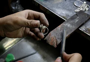 A man works on a silver ring at a workshop in Hanoi A man works on a silver ring at a workshop in Hanoi