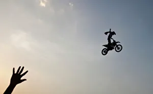 A member of audience waves at a rider performing a stunt during the Red Bull X-Fighters A member of audience waves at a rider performing a stunt during the Red Bull X-Fighters