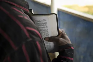 A member of the clergy reads from the Bible to Ebola Patients in the recovery wing of the A member of the clergy reads from the Bible to Ebola Patients in the recovery wing of the