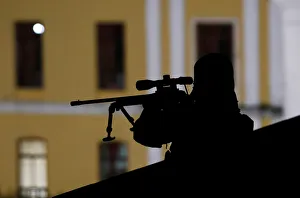 A member of police special forces monitors the area as activists march at the main A member of police special forces monitors the area as activists march at the main