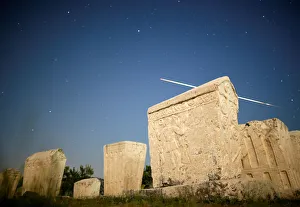 A meteor streaks past stars in the night sky above medieval tombstones during the Perseid A meteor streaks past stars in the night sky above medieval tombstones during the Perseid