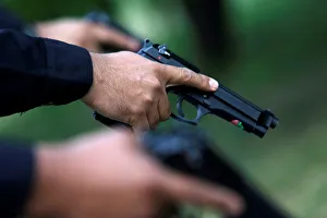 Mexican state police holds Beretta 9mm pistol at police barracks in Monterrey Mexican state police holds Beretta 9mm pistol at police barracks in Monterrey