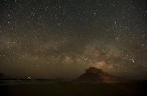 The Milky Way is seen in the night sky over rocks in the White Desert north of the The Milky Way is seen in the night sky over rocks in the White Desert north of the