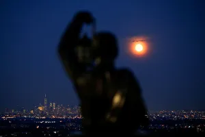 The full moon known rises over the skyline of New York and One World Trade Center as seen The full moon known rises over the skyline of New York and One World Trade Center as seen