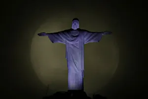 The moon is pictured behind the Christ the Redeemer statue ahead of the visit of Pope The moon is pictured behind the Christ the Redeemer statue ahead of the visit of Pope