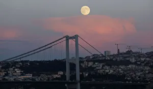 A full moon rises over the Bosphorus bridge in Istanbul A full moon rises over the Bosphorus bridge in Istanbul