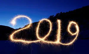 The numbers 2019 are written in the air with a sparkler near a tourist camp outside The numbers 2019 are written in the air with a sparkler near a tourist camp outside
