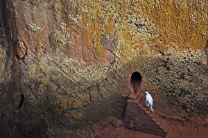 Orthodox Christian walks into one of 11 monolithic rock-cut churches Orthodox Christian walks into one of 11 monolithic rock-cut churches