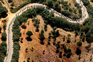 A pack of riders cycle during the third stage of the Tour of Spain cycling race between A pack of riders cycle during the third stage of the Tour of Spain cycling race between