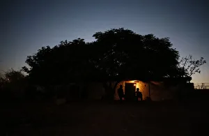 Palestinian Bedouins sit outside their dwelling in the West Bank village of Al-Eizariya Palestinian Bedouins sit outside their dwelling in the West Bank village of Al-Eizariya