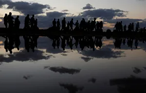 Palestinian demonstrators are reflected in rain water after attending a protest at the Palestinian demonstrators are reflected in rain water after attending a protest at the