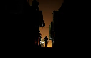 Palestinian man walks at Shatti (beach) refugee camp during power cut, in Gaza City Palestinian man walks at Shatti (beach) refugee camp during power cut, in Gaza City