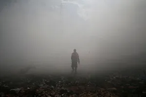 A Palestinian medic walks as tear gas was fired by Israeli troops during clashes near the A Palestinian medic walks as tear gas was fired by Israeli troops during clashes near the