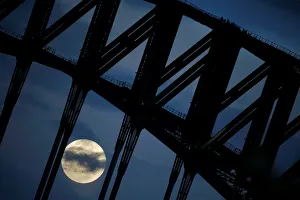 Participants in a Sydney Harbour Bridge Climb walk down the western span of the famous Participants in a Sydney Harbour Bridge Climb walk down the western span of the famous