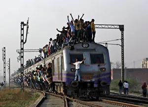 Passengers travel on an overcrowded train on the outskirts of New Delhi Passengers travel on an overcrowded train on the outskirts of New Delhi
