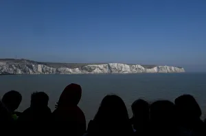 Passengers view the white cliffs of Dover from a cross-channel ferry between Dover in Passengers view the white cliffs of Dover from a cross-channel ferry between Dover in