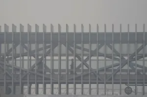 A pedestrian walks on a bridge on a polluted day in Beijings central business area A pedestrian walks on a bridge on a polluted day in Beijings central business area