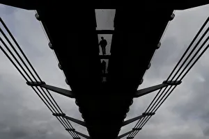 Pedestrians cross the Millenium Bridge in central London Pedestrians cross the Millenium Bridge in central London