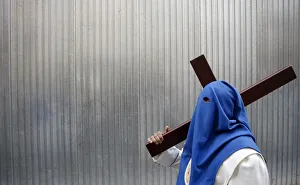 A penitent of El Prendimiento brotherhood takes part in a procession during Holy Week A penitent of El Prendimiento brotherhood takes part in a procession during Holy Week