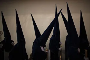 Penitents take part in the procession of Estrella brotherhood during Holy Week in Penitents take part in the procession of Estrella brotherhood during Holy Week in