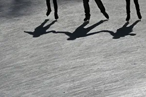 People cast their shadows as they skate on the Wollman Rink in Central Park in the People cast their shadows as they skate on the Wollman Rink in Central Park in the
