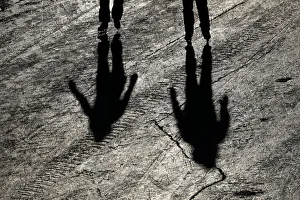 People cast shadows while skating on the Rideau Canal in Ottawa People cast shadows while skating on the Rideau Canal in Ottawa