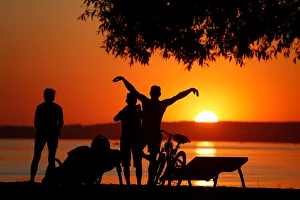 People enjoy sunset at a lake on the outskirts of Minsk People enjoy sunset at a lake on the outskirts of Minsk