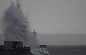People take images as large waves and high winds associated with Storm Ffion hit the People take images as large waves and high winds associated with Storm Ffion hit the