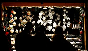 People look at Christmas decorations at a Christmas market in front of the Schoenbrunn People look at Christmas decorations at a Christmas market in front of the Schoenbrunn