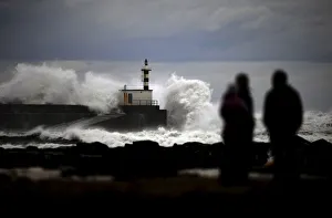 People look at huge waves crashing on the San Esteban de Pravia seafront People look at huge waves crashing on the San Esteban de Pravia seafront