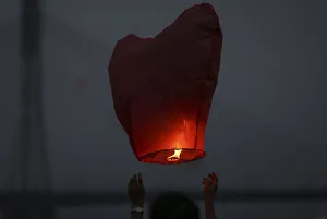 People release paper lanterns during a celebration for the New Year of the Dai minority People release paper lanterns during a celebration for the New Year of the Dai minority